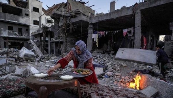 A Palestinian woman preparing food in Gaza, March, 2024.