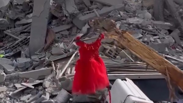 A girl's dress is left hanging amid the rubble caused by Israeli bombings in Gaza, March 17, 2024.