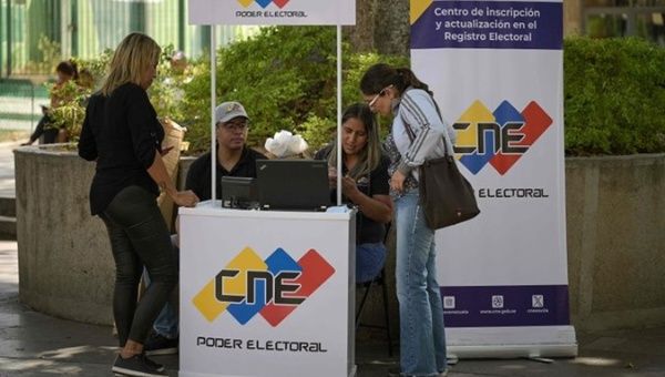 Venezuelans verify their data at a stand of the National Electoral Council.
