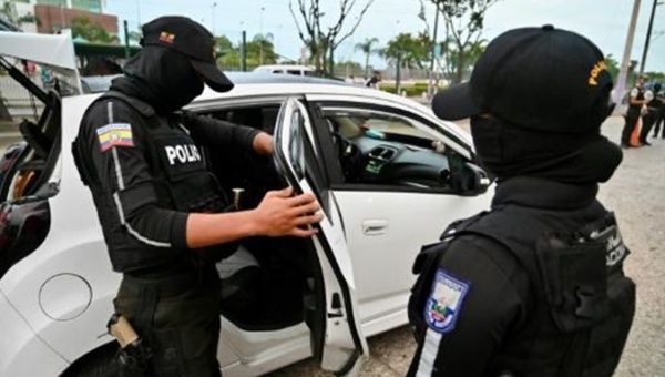 Ecuadorian police inspect a vehicle, 2024.