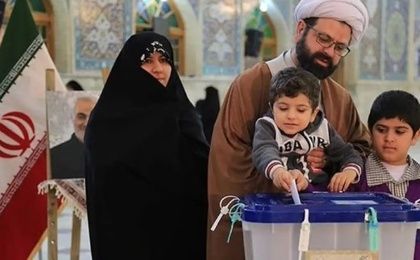 Iranian citizen votes accompanied by his family.